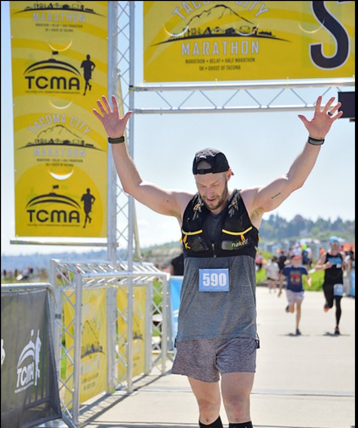 Kevin O'Hagan crossing the finish line at the Tacoma City Marathon